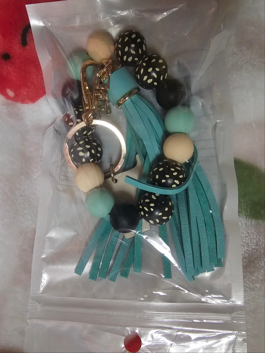 Wristlet with wood cow focal and tassel