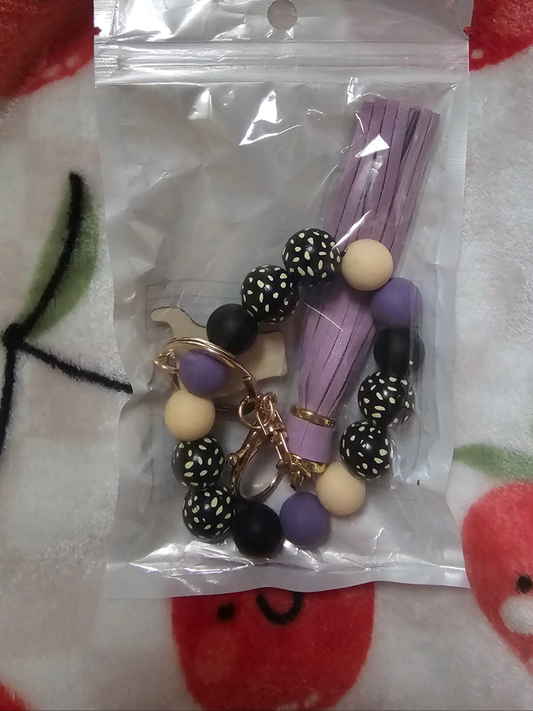 Wristlet with wood cow focal and tassel