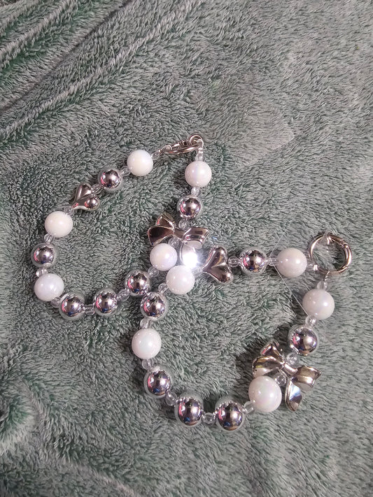 White and silver phone dangle strap.