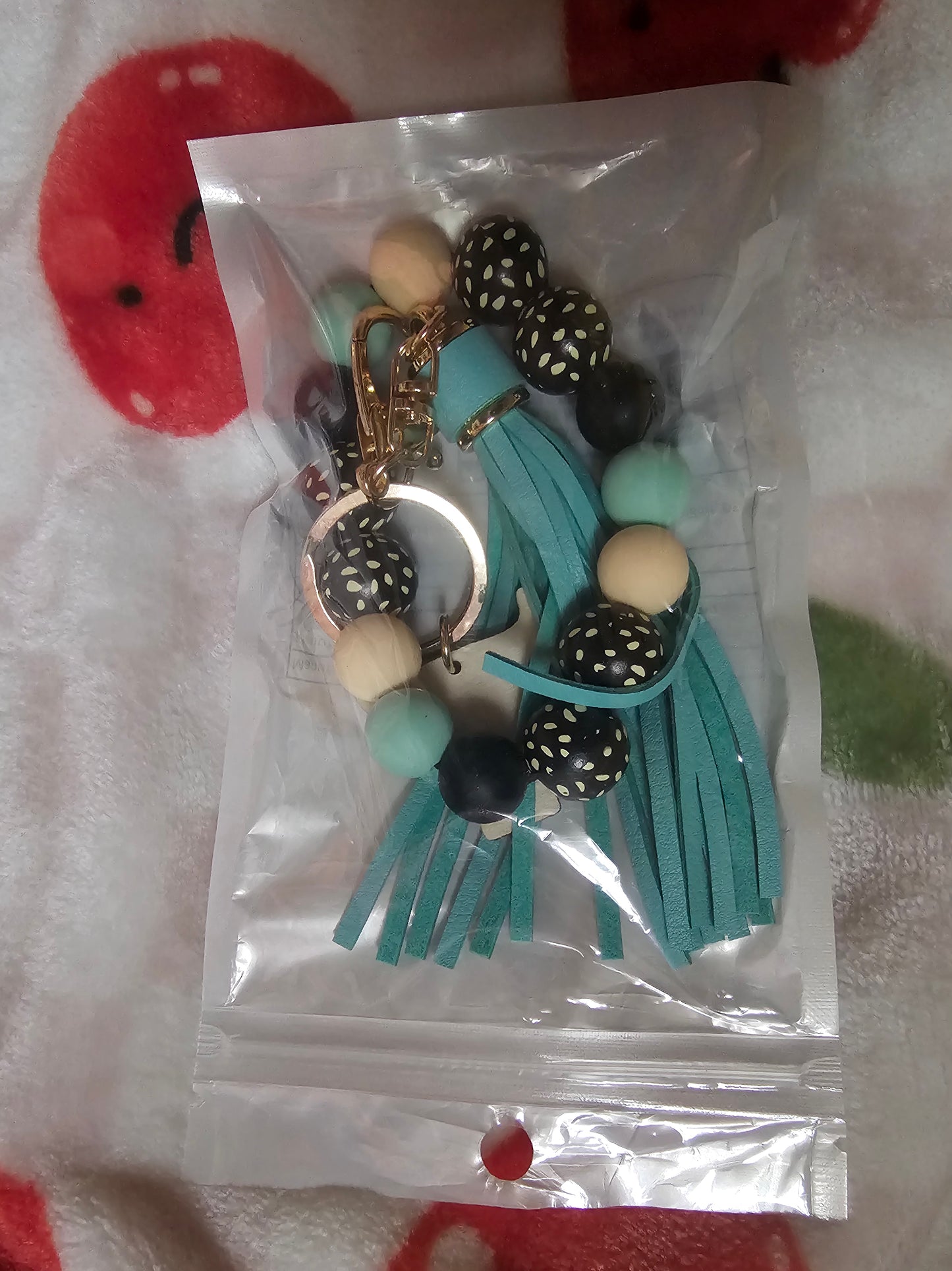 Wristlet with wood cow focal and tassel