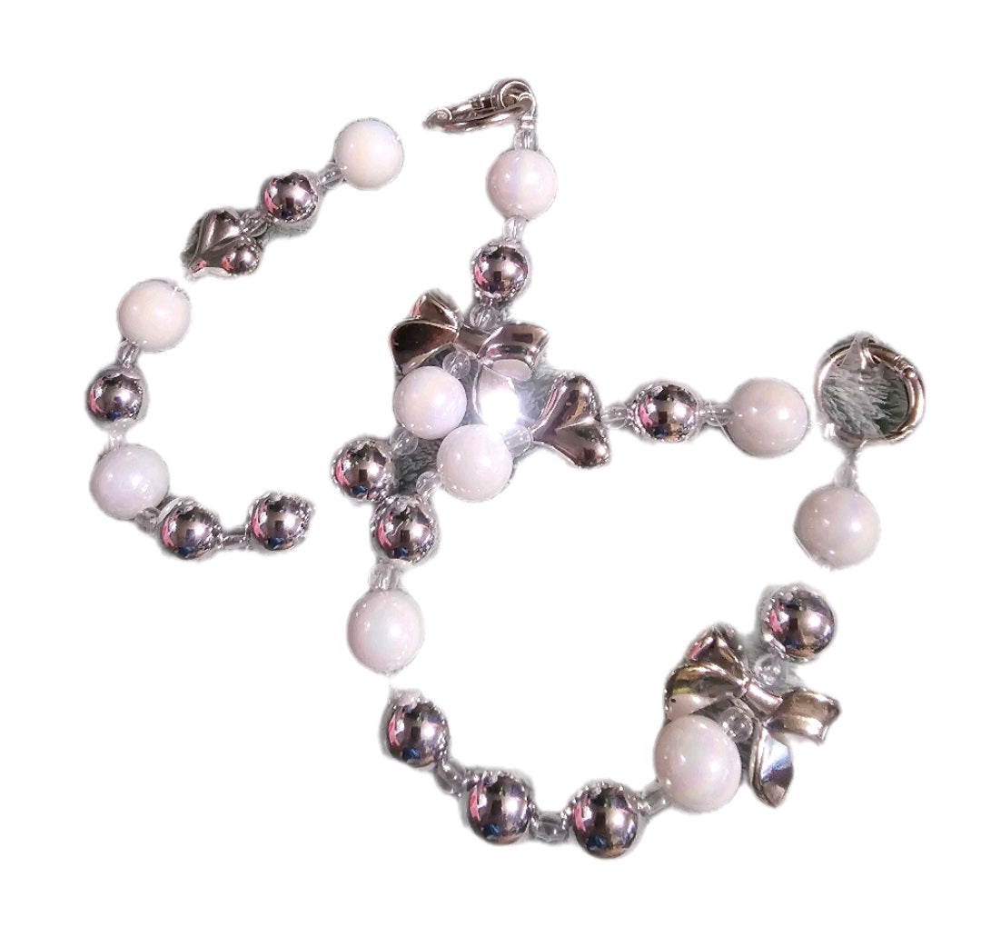 White and silver phone dangle strap.
