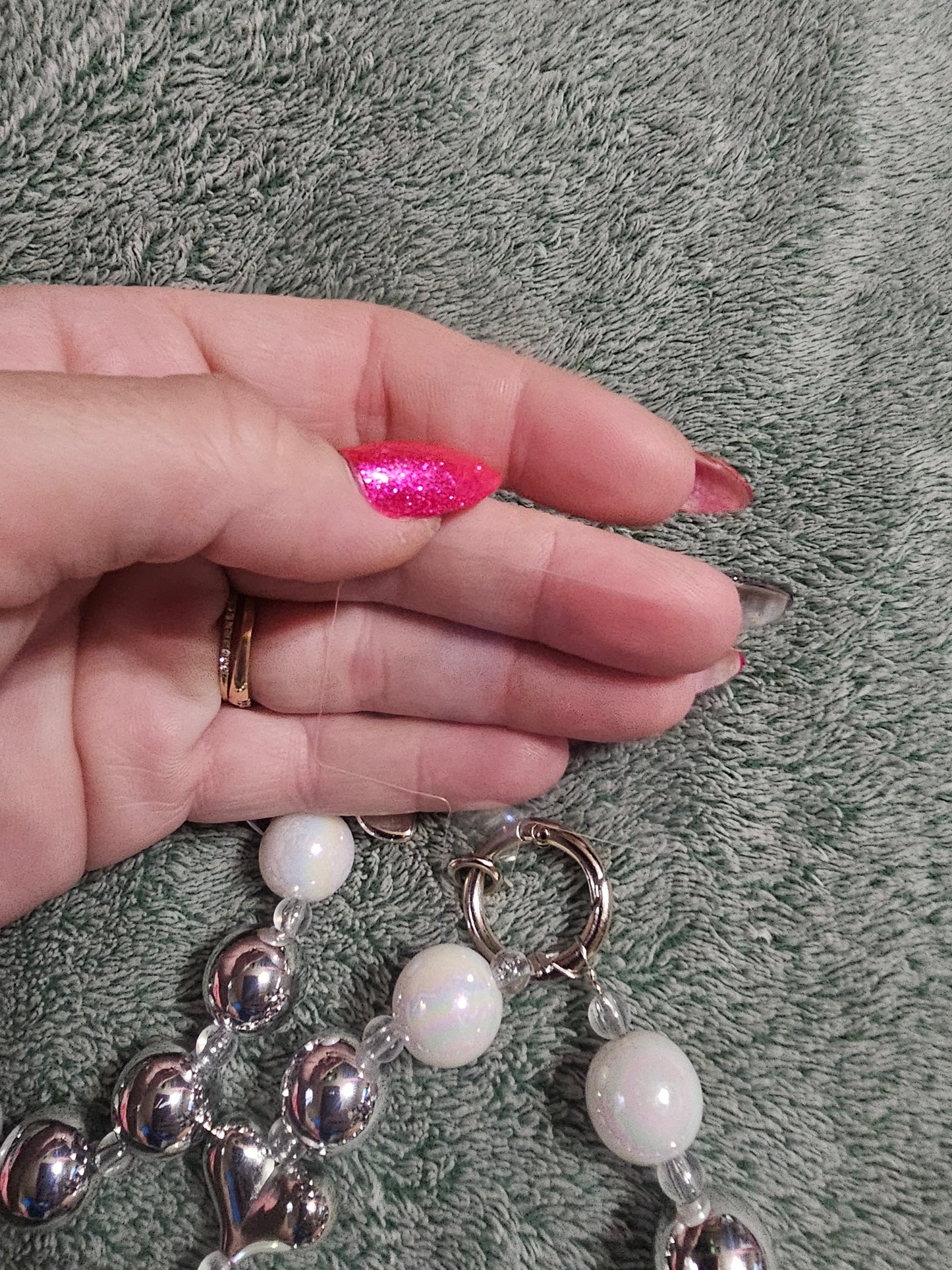 White and silver phone dangle strap.